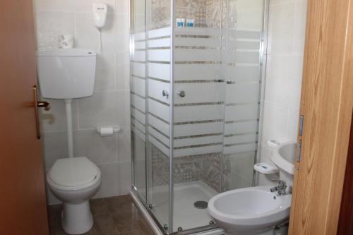 a bathroom with a shower and a toilet and a sink at Agriturismo La Maddalena in Acate