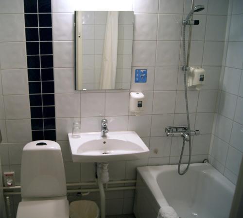 a bathroom with a sink and a toilet and a tub at Sure Hotel by Best Western City Jonkoping in Jönköping
