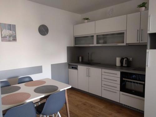 a kitchen with a table and chairs in a room at Apartmán Jestřáb č. 23 - u kabinky in Janske Lazne