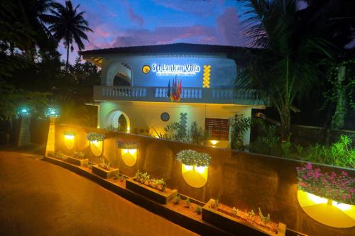 a building with lights on the side of a street at SRI LANKAN VILLA in Galle