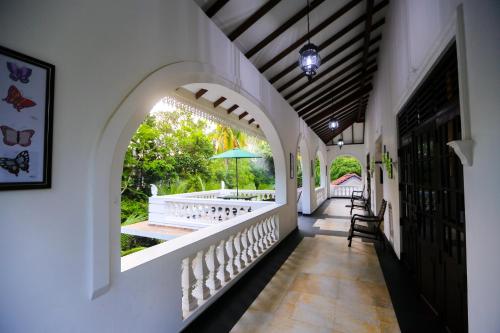 a hallway of a house with an archway and a patio at SRI LANKAN VILLA in Galle