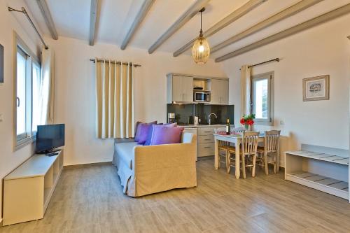 a living room with a couch and a table at Alsalos villas in Amoopi