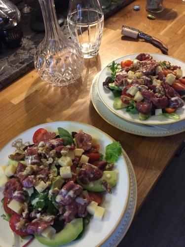 two plates of food on a wooden table at La Grenouille Noire in Marcillat-en-Combraille