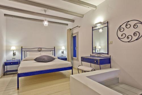 a bedroom with a bed and a mirror and a sink at Alsalos villas in Amoopi