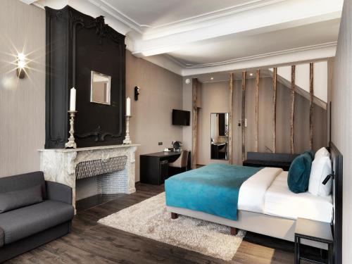a bedroom with a bed and a fireplace at Hotel Harmony in Ghent