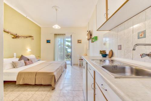a kitchen with a bed and a sink in a room at Panorama Studios & Apartments in Amoudi