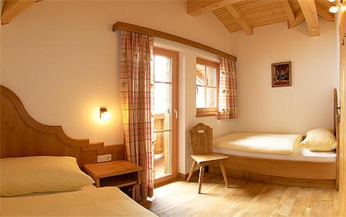 a bedroom with two beds and a window at Großarler Jagdhaus in Grossarl