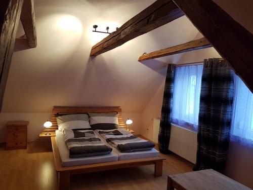 a bedroom with a bed with pillows and a window at Lukas Oscar in Bad Blumau