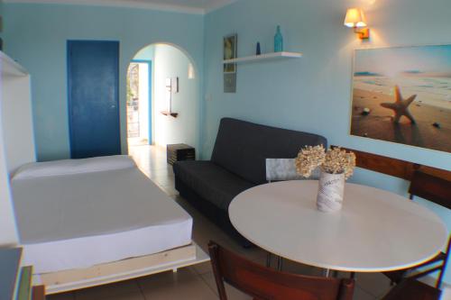 a living room with a couch and a table at Agi Marina Apartments in Roses
