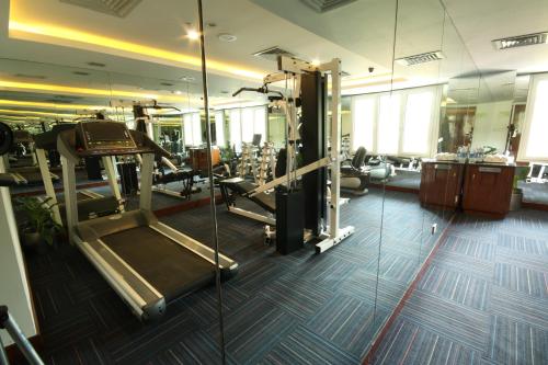 a gym with a treadmill and a elliptical machine at The Elanza Hotel, Bangalore in Bengaluru