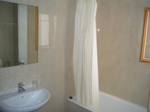 łazienka z umywalką i zasłoną prysznicową w obiekcie Hostal Tierramar w El Arenal