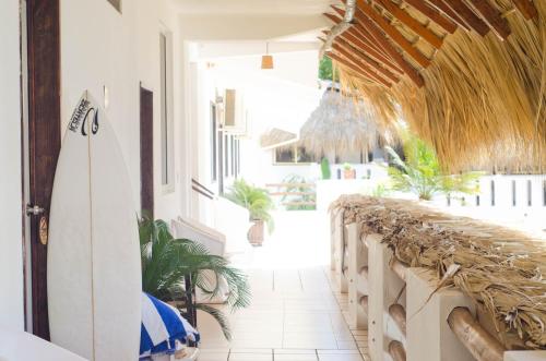 a room with a surfboard on the side of a building at Bungalows Zicatela in Puerto Escondido