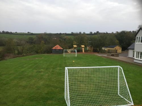 a soccer field with a goal in the grass at Four Winds,Kinsale Town,Exquisite holiday homes,sleeps 26 in Kinsale