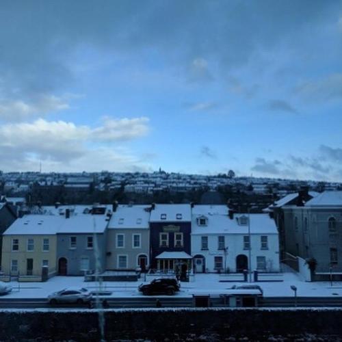 a group of buildings with snow on the roofs at Anam Cara B&B in Cork