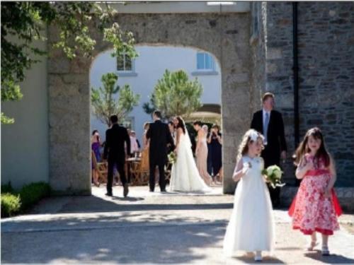 a bride and groom walking down the aisle at a wedding at Tulfarris Hotel and Golf Resort in Blessington