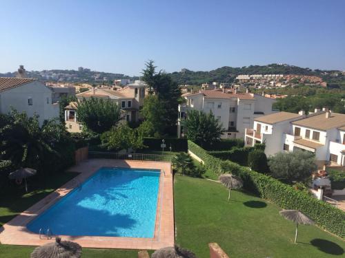 - une piscine dans une cour avec des maisons dans l'établissement Apartamento S'Agaró Fagoi, à S'Agaro