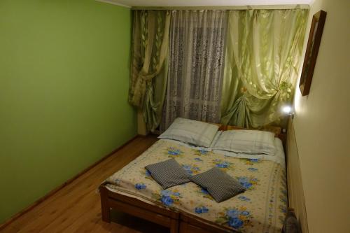 a bedroom with a bed with two books on it at Pokoje u Szlachty in Szczawnica