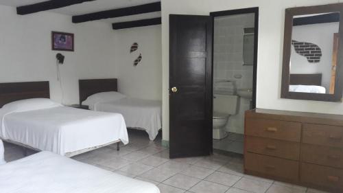 Postel nebo postele na pokoji v ubytování Hotel De Cortez y Larraz