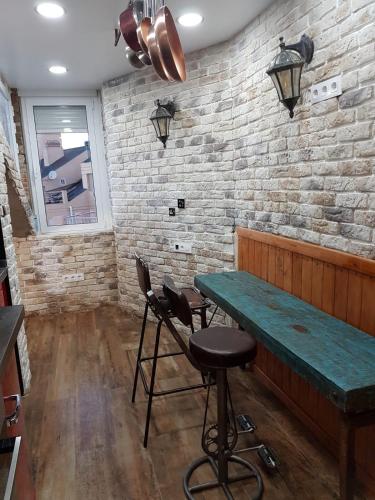 a bar with a green table and two chairs at Tiny apartment on the roof touching Gibraltar in La Línea de la Concepción
