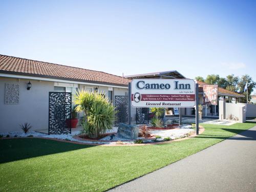 a camera inn sign in front of a house at Cameo Inn Motel in West Wyalong