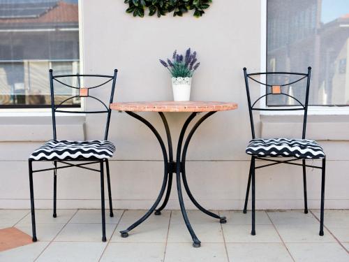 a table and two chairs sitting next to a window at Cameo Inn Motel in West Wyalong