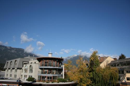 a building with a clock tower in a city at Gibbons Life Accommodations in Whistler