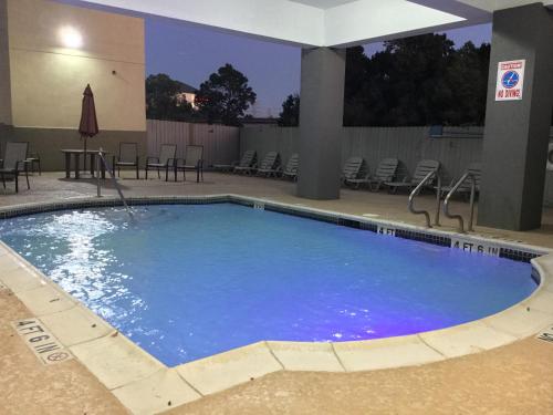 a large swimming pool in a hotel room at Sonesta Essential IAH Airport JFK Boulevard - Newly Renovated in Houston