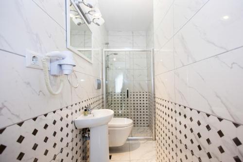 a bathroom with a toilet, sink, and mirror at Sultanahmet Inn Hotel in Istanbul
