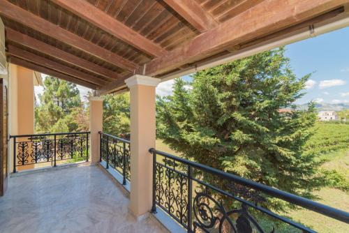 a balcony with a view of a tree at Villa Fos in Gaïtánion