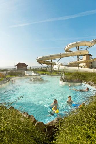 a group of people swimming in a water park at Center Parcs Sauerland Winterberg-Medebach in Medebach