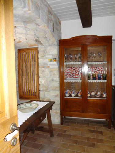 a bathroom with a sink and a wooden cabinet at Bed And Breakfast Pa' Carrera in Fragneto Monforte