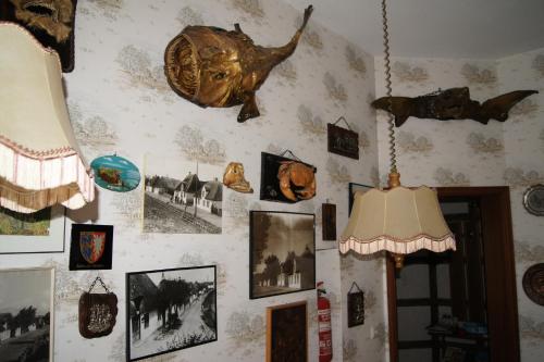a wall with a bunch of pictures on it at Hotel Dorfkrug Büsum in Büsum