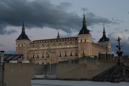 a large building with turrets on top of it at Antidoto Rooms San Agustín - Recomendado para adultos in Toledo