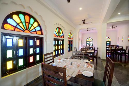 a dining room with a table and stained glass windows at Moti Mahal - A Heritage Haveli in Pushkar