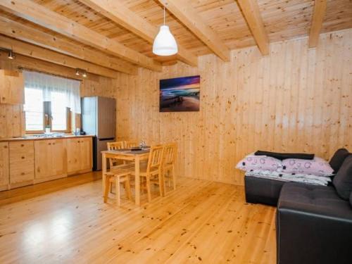 a living room with a couch and a table at Agromarko in Ustronie Morskie