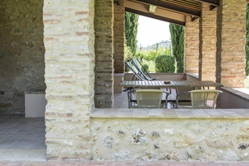 an outdoor patio with a table and chairs at Monteriggioni Suite in Monteriggioni