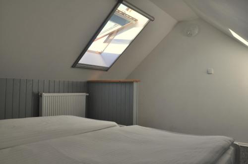 a bedroom with a bed and a window at Gościniec Kaszubski Homestay in Białogóra