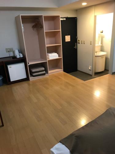 a living room with a room with a television and a room with a bathroom at Kagoshima Daiichi Hotel Kishaba in Kagoshima