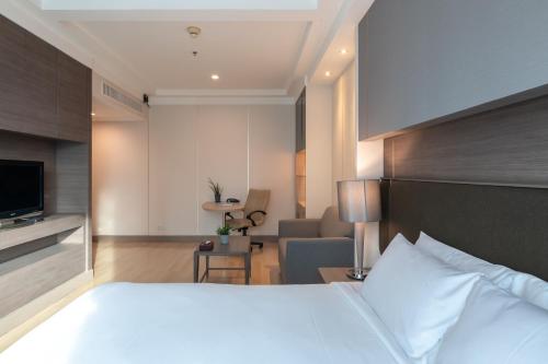 Katil atau katil-katil dalam bilik di Jasmine City Hotel