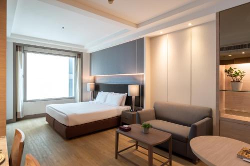 Katil atau katil-katil dalam bilik di Jasmine City Hotel