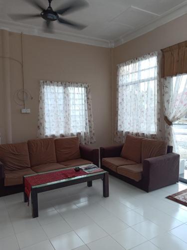 a living room with a couch and a coffee table at Hotel Murah Pasir Puteh in Pasir Puteh