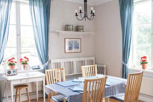 a dining room with a blue table and chairs at 58 Turistvägen Järvsö in Järvsö