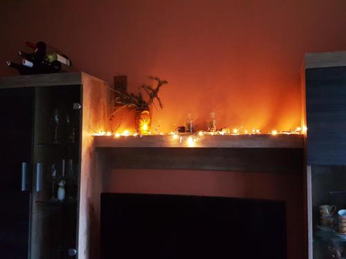 a fire in a room with lights on a mantle at Apartment Mariazell Bürgeralpe in Mariazell