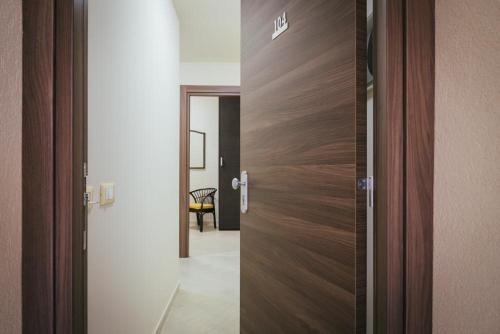 a wooden door in a room with a hallway at Hotel Costa Azul in Balestrate