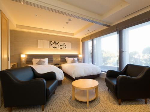 Postel nebo postele na pokoji v ubytování Hotel Shiki Utsubo Park
