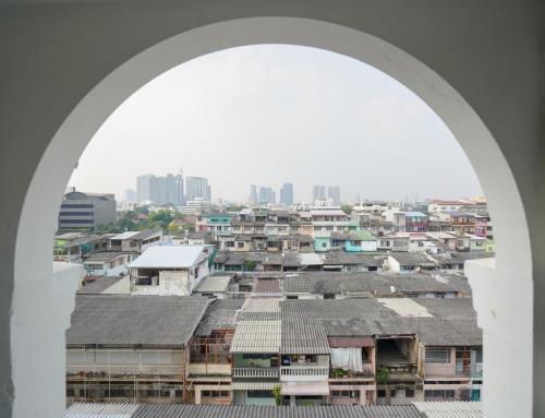 an archway view of a city from a building at Romance Hotel Sukhumvit 97 in Bangkok