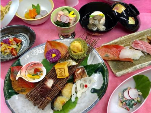 a group of plates of food on a pink table at Hotel Shiki Utsubo Park in Osaka