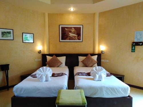 a hotel room with two beds with bows on them at Palm Garden Resort in Khao Lak