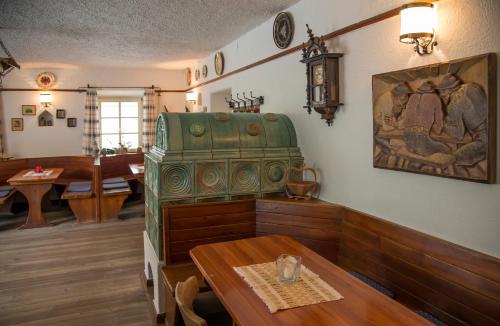 a dining room with a table and a green chair at Gasthof Obermair in Chienes