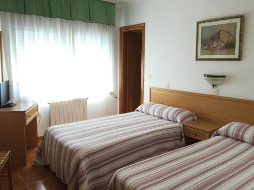 Katil atau katil-katil dalam bilik di Hostal-Restaurante Casa Giz